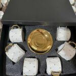 Gold and white Tea set with saucers.